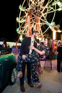 Couple dancing in front of Ferris wheel at The San Diego Museum of Art Bloom Bash