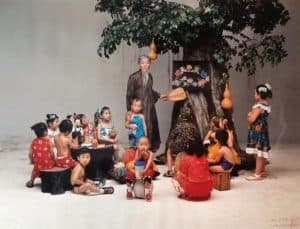 Staged photograph by Wang Qingsong of teacher and students with tree