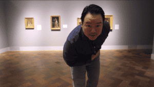 Actor bowing inside art museum gallery