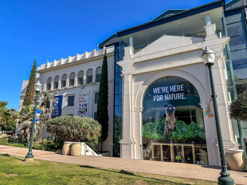 Entrance Facade Of The San Diego Natural History Museum With A "We're Here For Nature" Banner In Balboa Park, San Diego, California